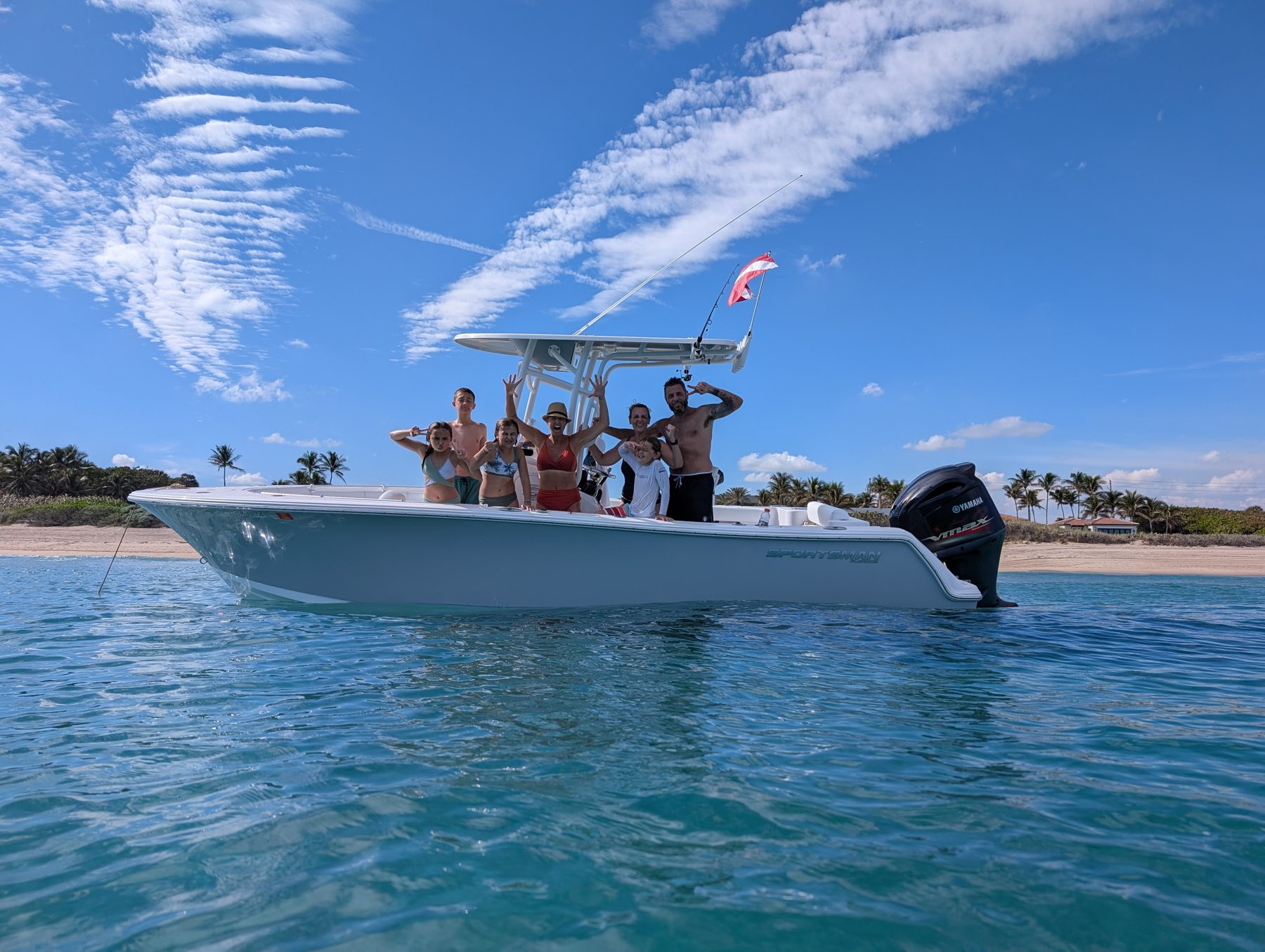 The Anderson family waving from their boat off the Florida coast